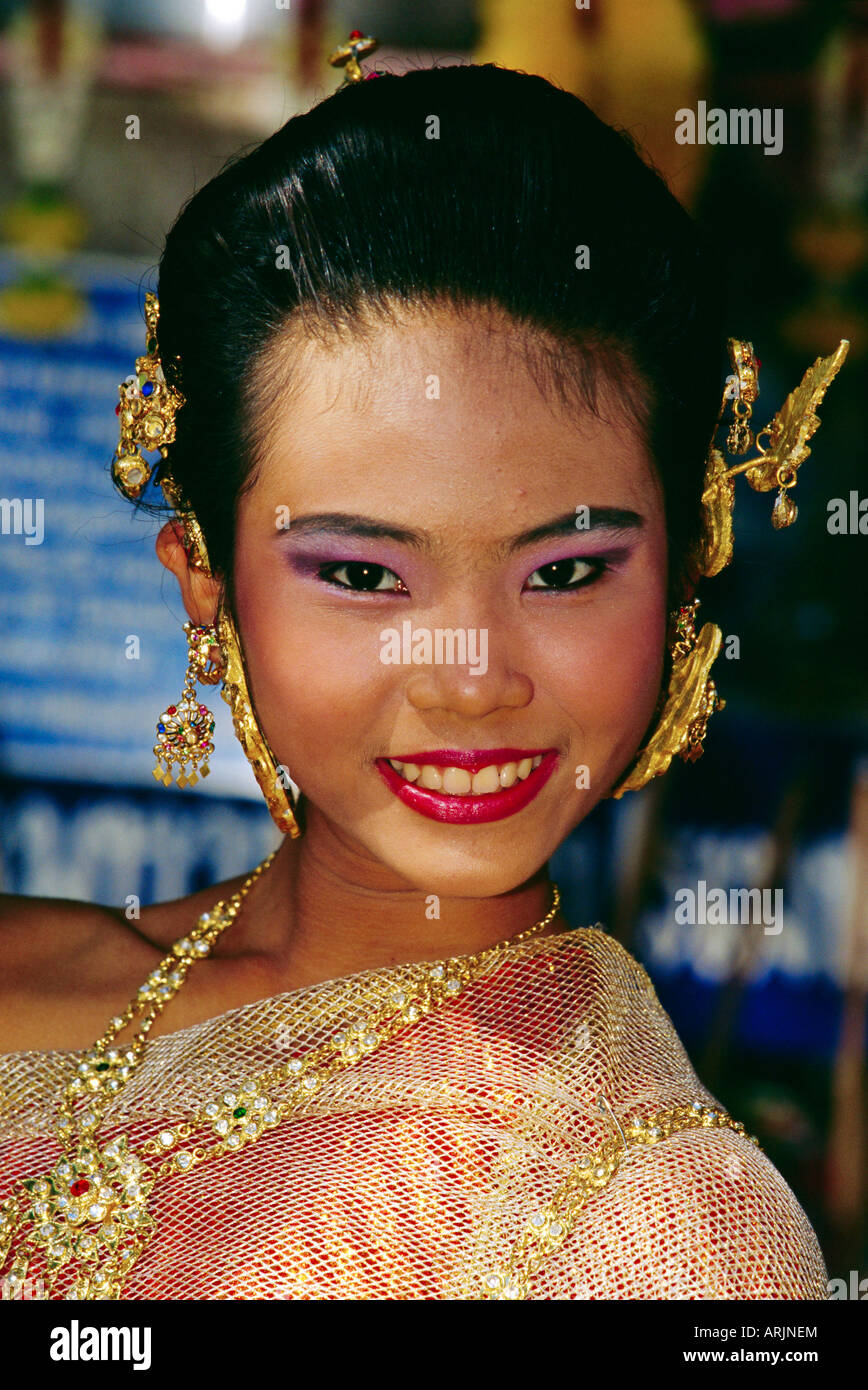 Portrait of a young Thai lady adorned with golden jewellery, Bangkok, Thailand Stock Photo