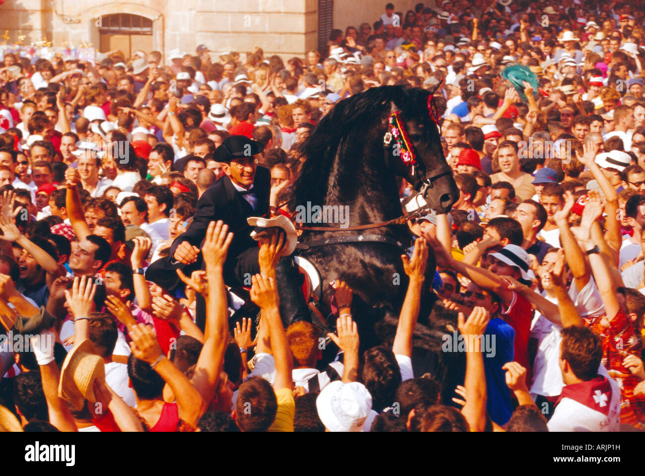 Rider on a rearing horse among the crowds during Sant Joans festival, Ciutadella, Minorca, Spain Stock Photo