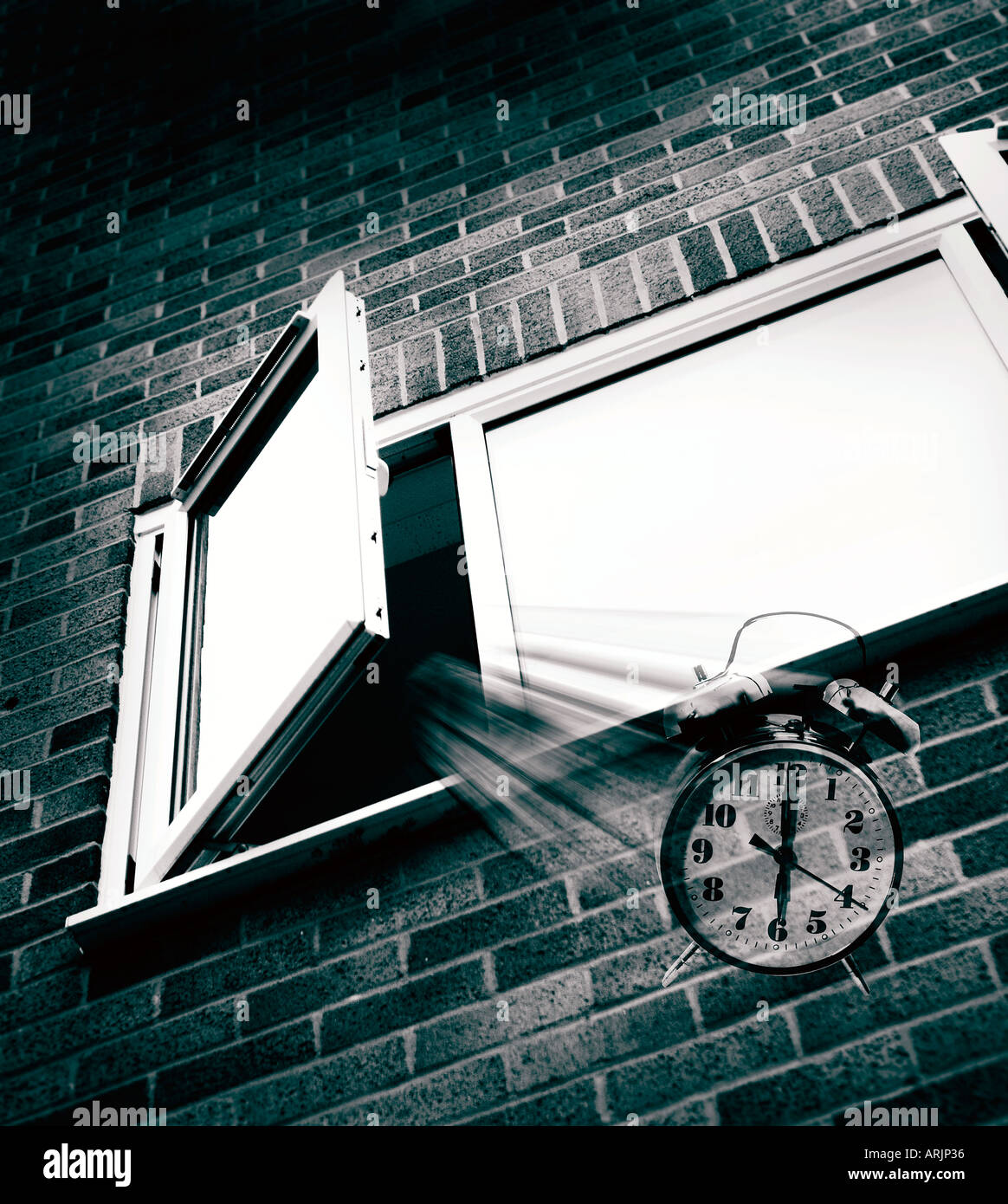 Alarm clock being thrown out of a bedroom window Stock Photo