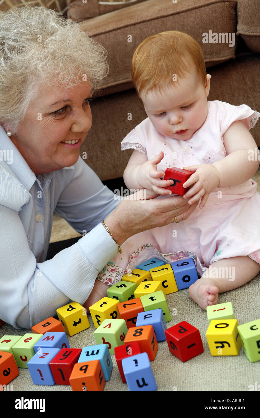 Six month old baby playing with building blocks with grandmother Stock Photo Alamy