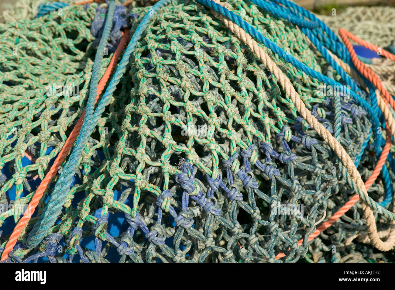 Fishing Nets hanging over harbour wall New Quay Ceredigion Wales Stock Photo