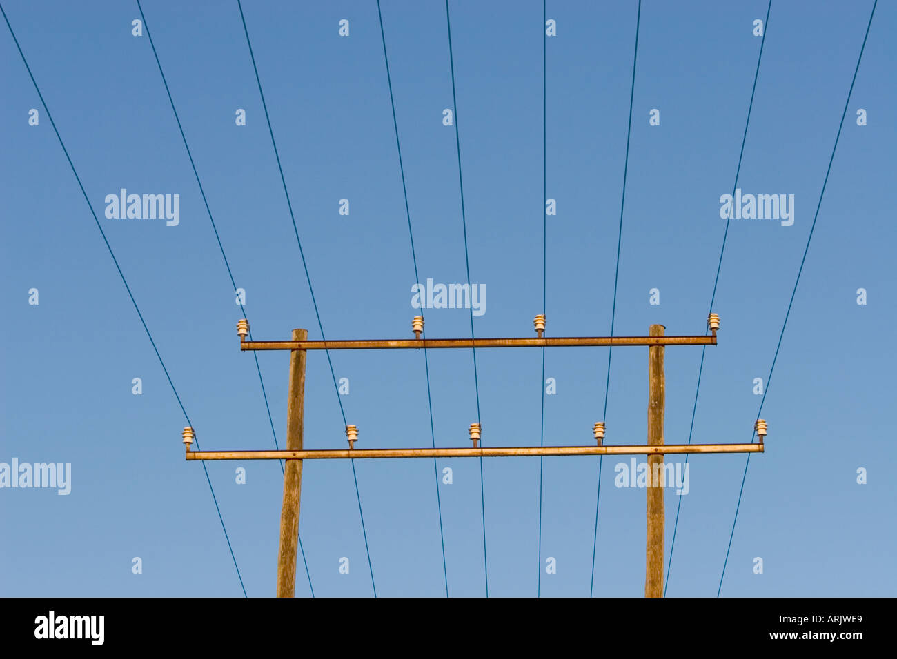 Power line using double wooden pylons made of pressure treated wood, Finland Stock Photo