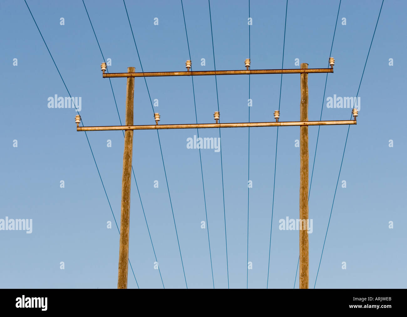Power line using double wooden pylons made of pressure treated wood , Finland Stock Photo