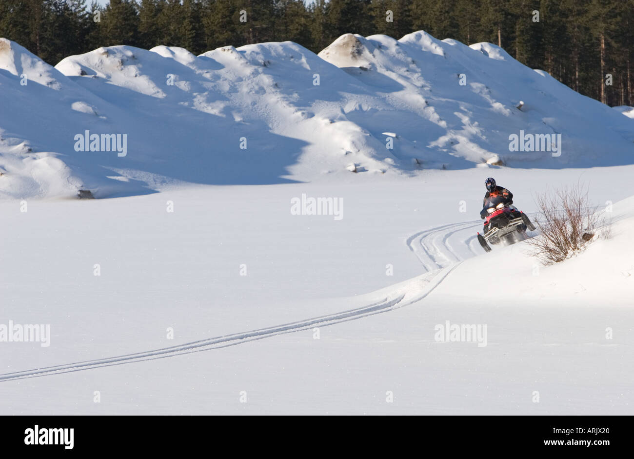 Young man driving snowmobile at Winter , Finland Stock Photo