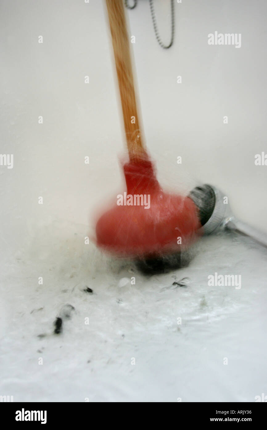 DEU, Germany : Housecleaning in a private house/apartment. Cleaning of a blocked outflow in a bathtub Stock Photo