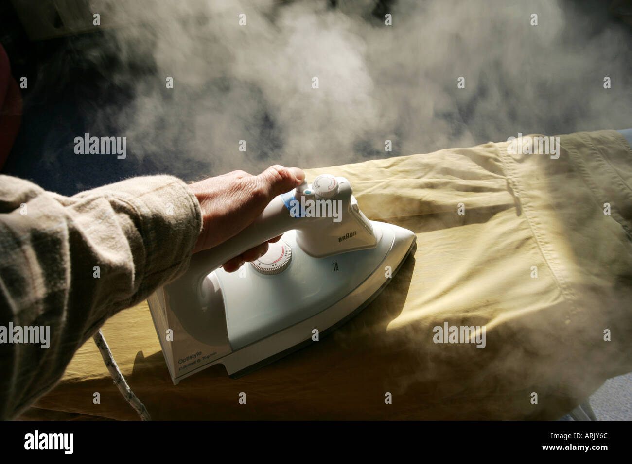 DEU, Germany : Iron of laundry at home. Steam iron Stock Photo