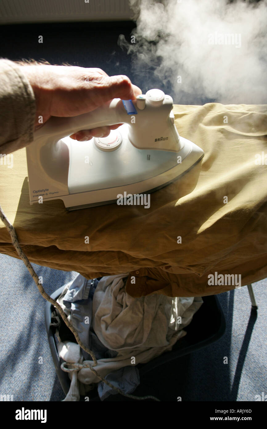 DEU, Germany : Iron of laundry at home. Steam iron Stock Photo