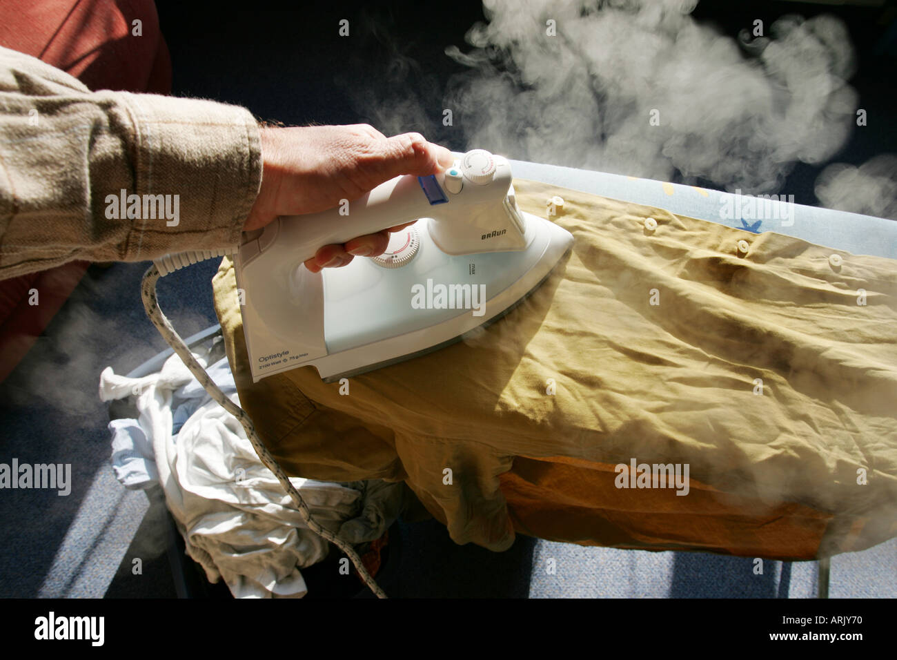 DEU, Germany : Iron of laundry at home. Steam iron Stock Photo