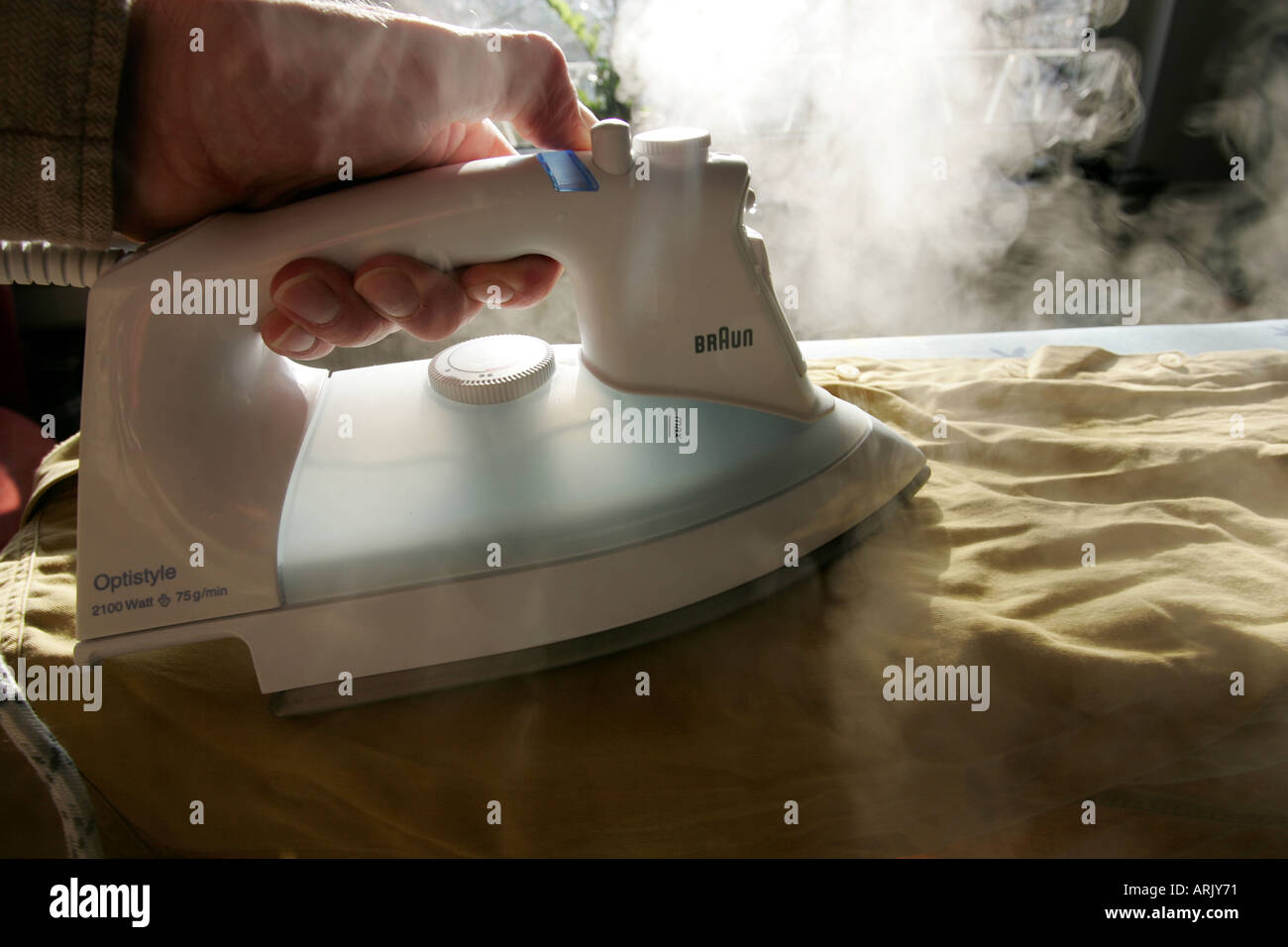 DEU, Germany : Iron of laundry at home. Steam iron Stock Photo