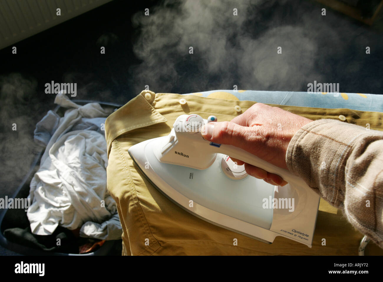 DEU, Germany : Iron of laundry at home. Steam iron Stock Photo