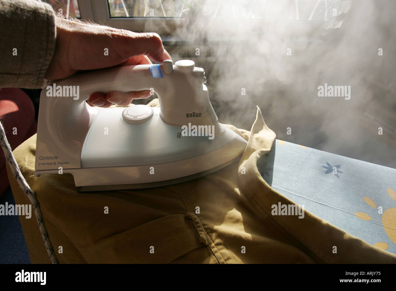 DEU, Germany : Iron of laundry at home. Steam iron Stock Photo