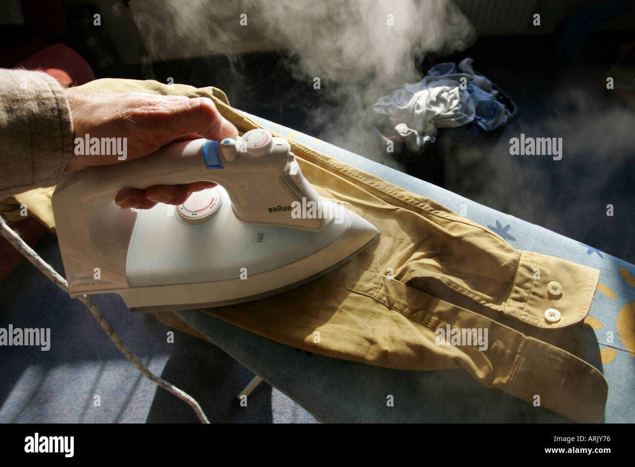 DEU, Germany : Iron of laundry at home. Steam iron Stock Photo