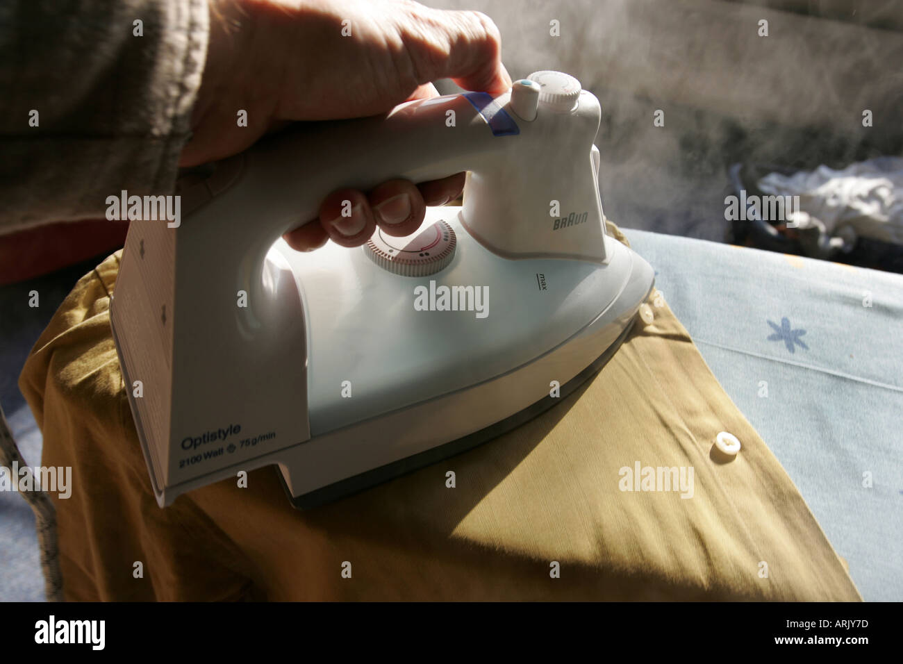 DEU, Germany : Iron of laundry at home. Steam iron Stock Photo