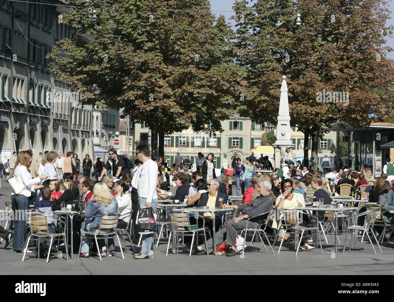 People enjoying the autumn sunshine in street cafe Waisenhausplatz in the Swiss capital city Berne. Stock Photo