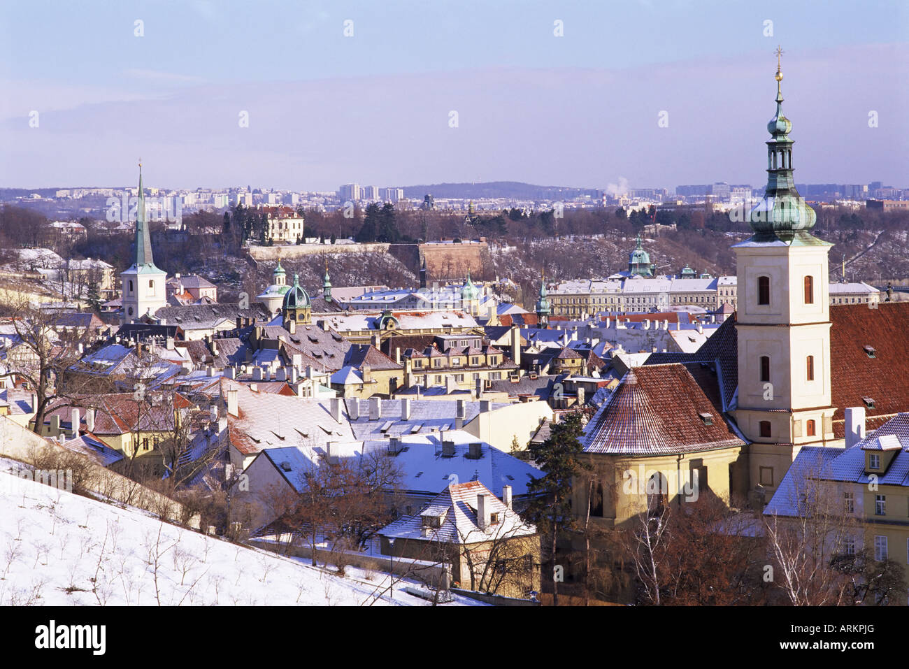 Snow covered Baroque church of Our Lady Victorious, and rooftops of Mala Strana suburb, Hradcany, Prague, Czech Republic Stock Photo