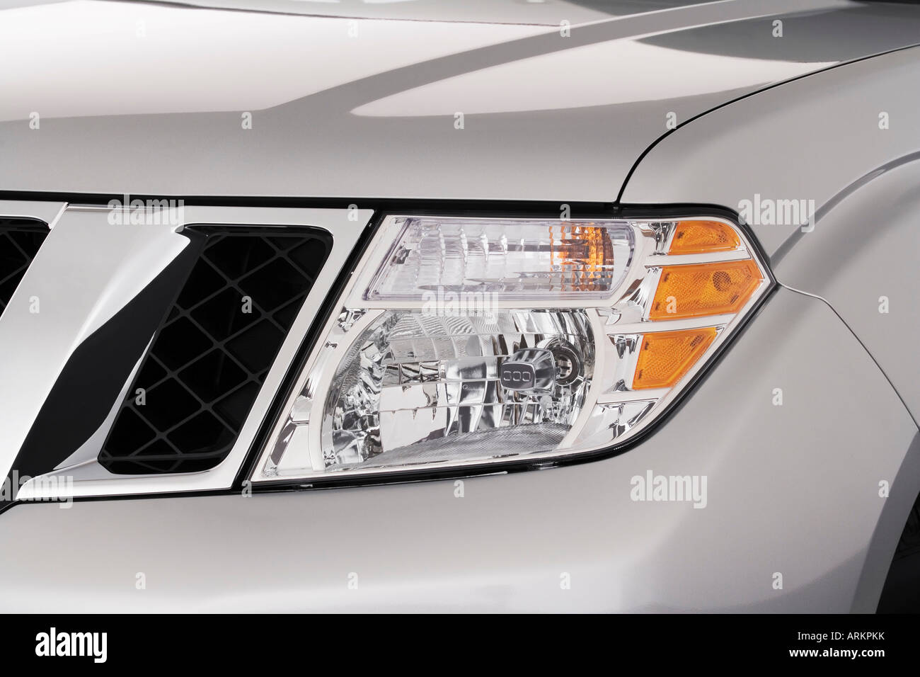 2008 Nissan Pathfinder SE in Silver - Headlight Stock Photo