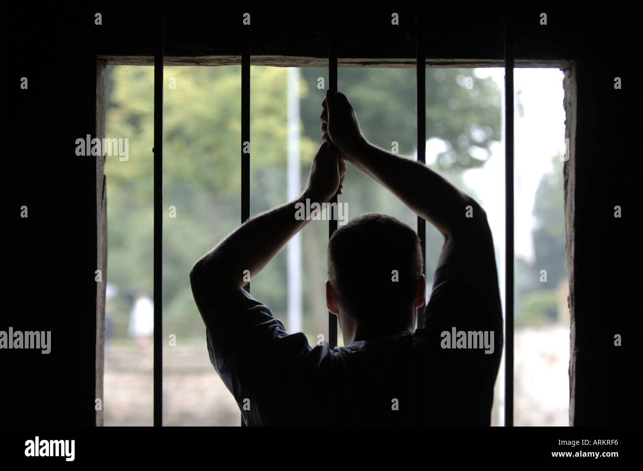 man in jail longing for freedom Stock Photo