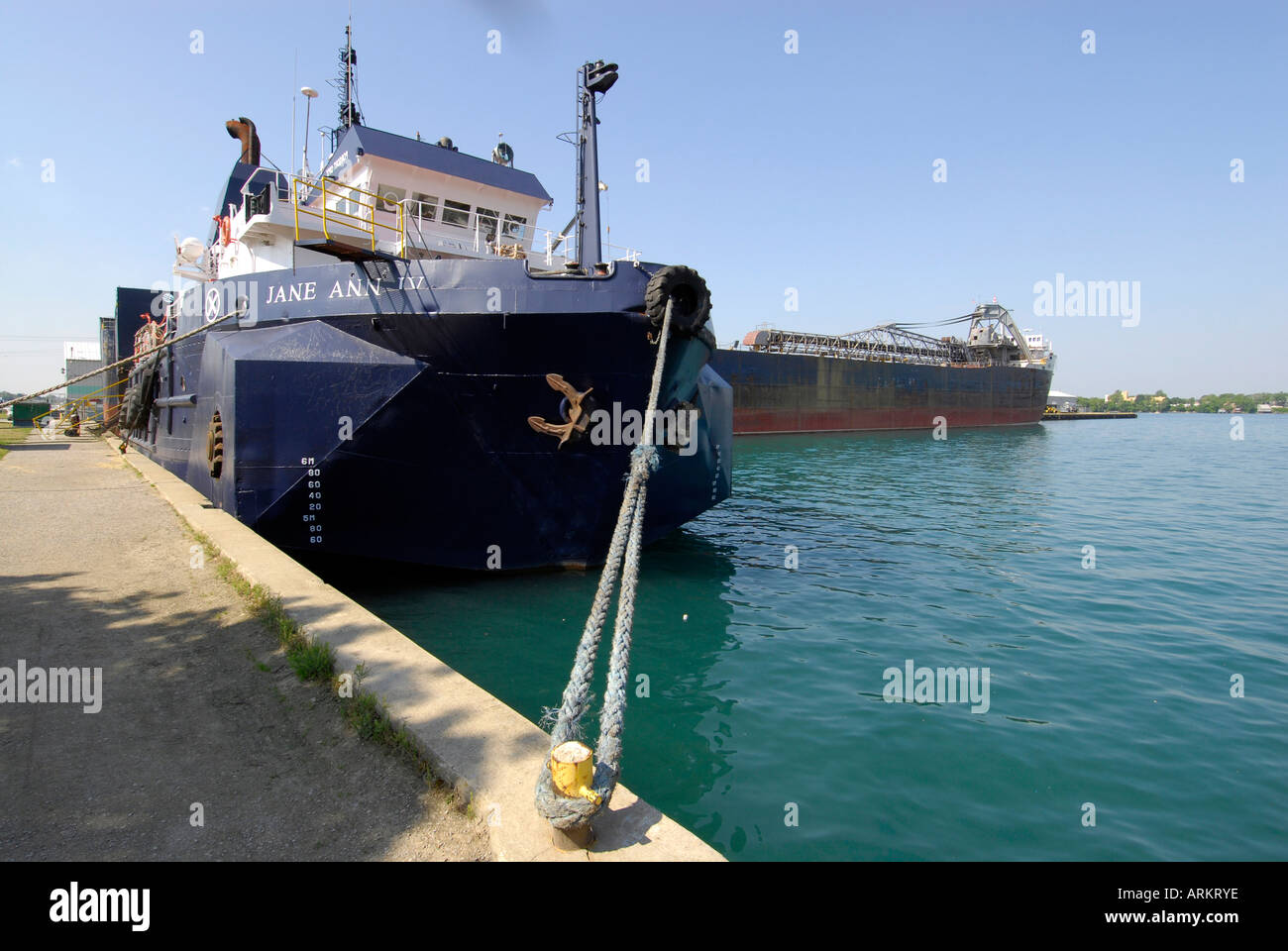 Tug boat at drydock with sister lake freighter at Port Huron Michigan on Lake Huron and the St Clair River Stock Photo