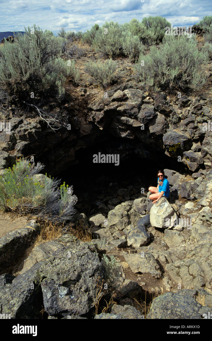 Female tourist in the entrance to Captain Jack's Cave Lava Beds