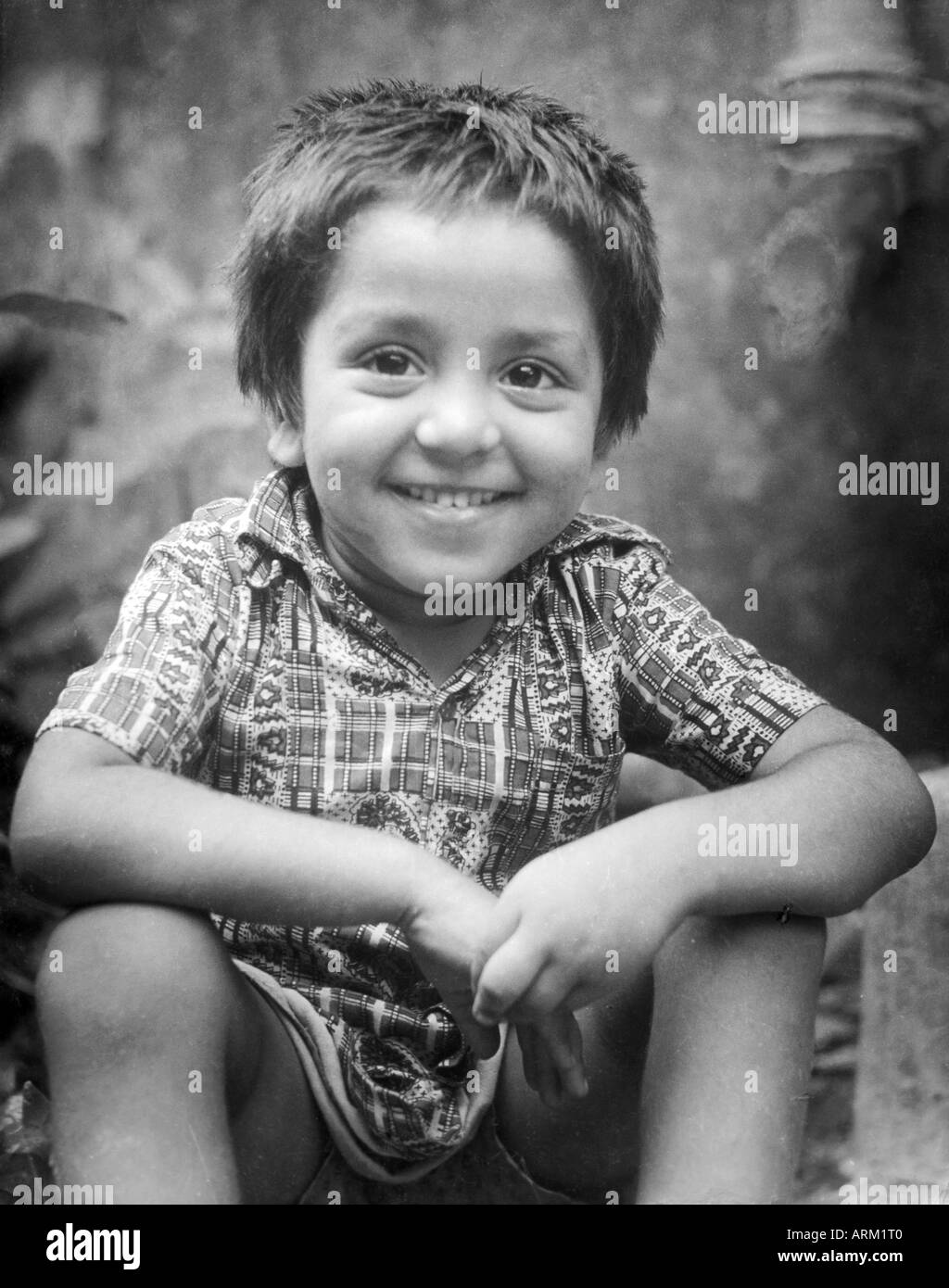 Indian boy smiling portrait India 1940s old vintage 1900s picture Stock Photo