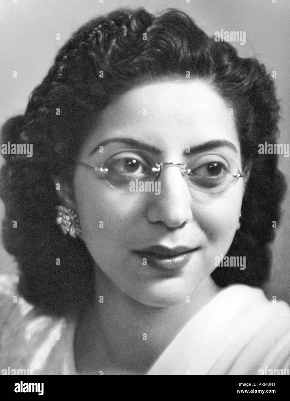 VRB101286 Indian woman with specs in white dress portrait in studio Kulri Mussorie Uttar Pradesh India 1940s Stock Photo