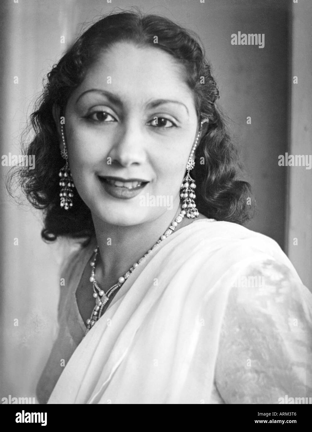 Indian Woman In Short Hair Wearing White Dress And Necklace Ear