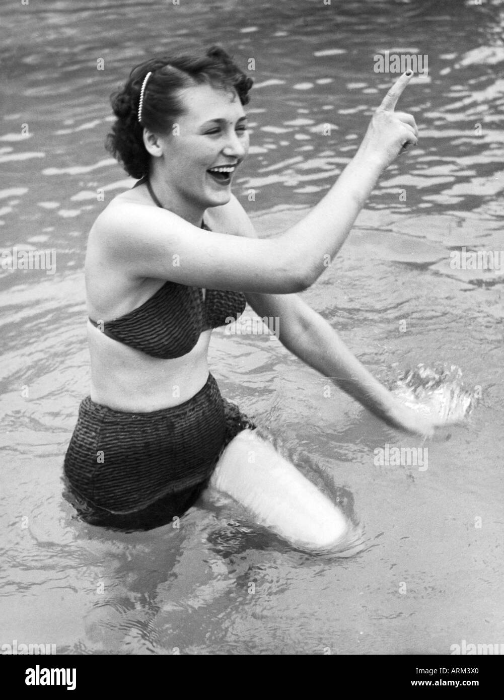 British woman in bikini playing in water Kulri Mussorie Uttar Pradesh India 1940s old vintage picture Stock Photo