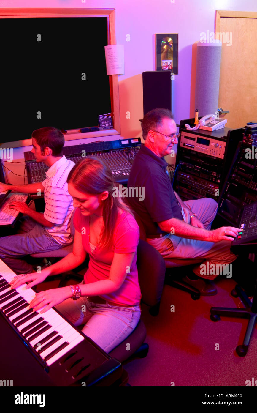 Students Learning Electronic Keyboard from Music Teacher Stock Photo
