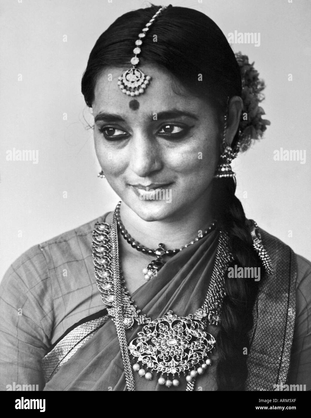 old vintage Indian woman in bridal jewelry bindi on forehead portrait in studio Maharashtra India 1940s Stock Photo