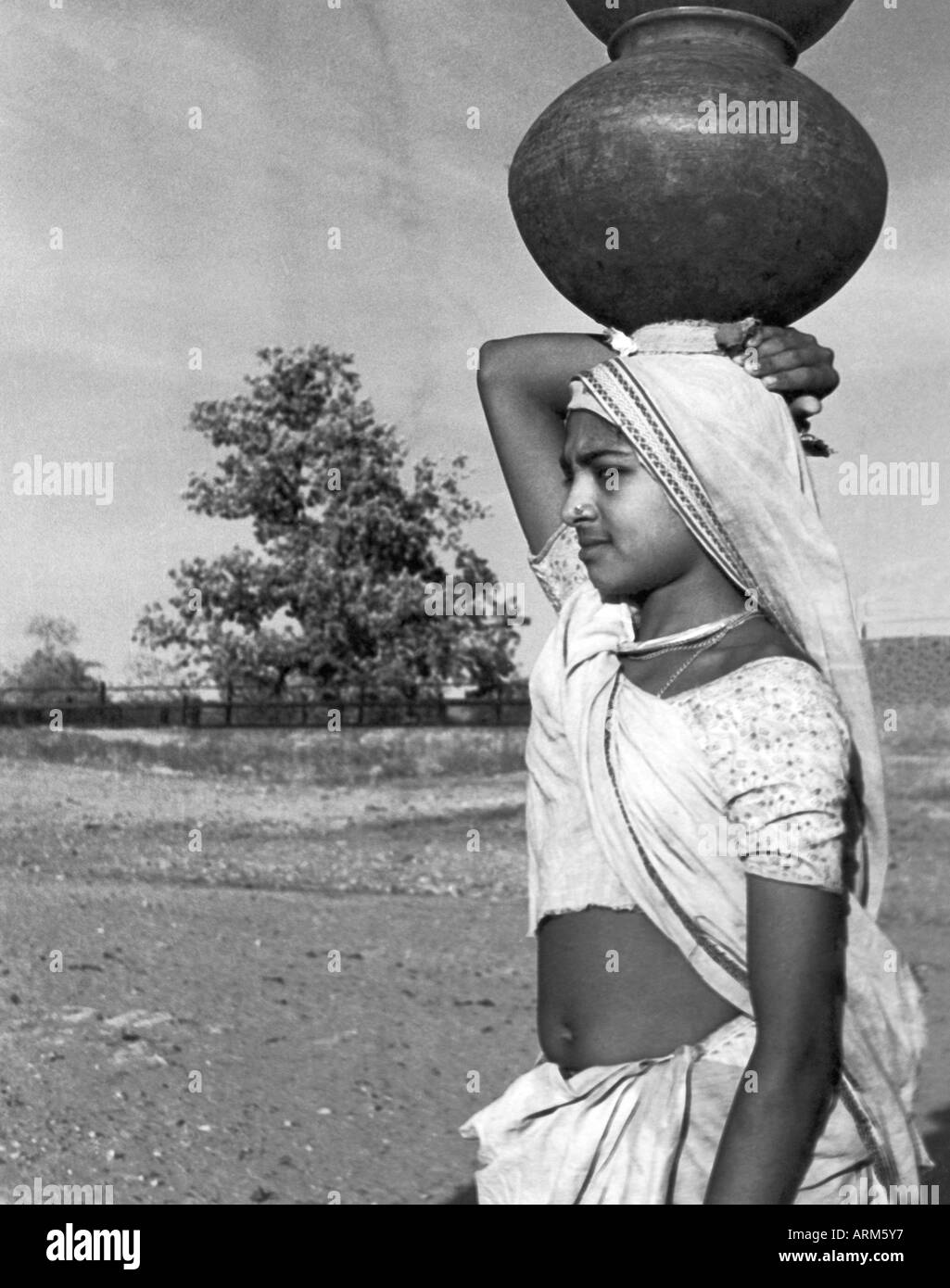 Indian girl in sari holding water pot on head Saurashtra Gujarat India