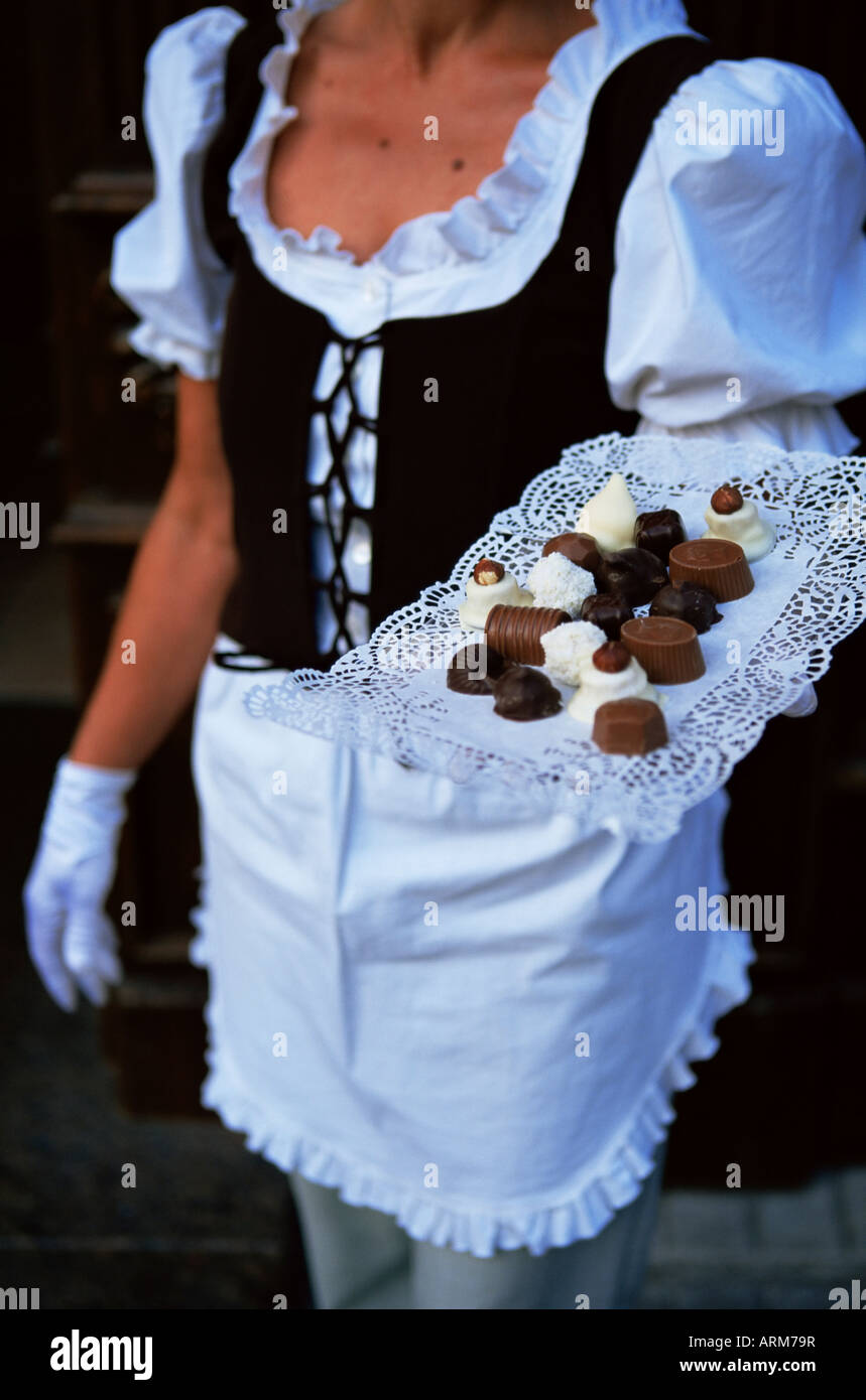 Waitress carrying tray of chocolate, Vilnius, Lithuania, Baltic States, Europe Stock Photo