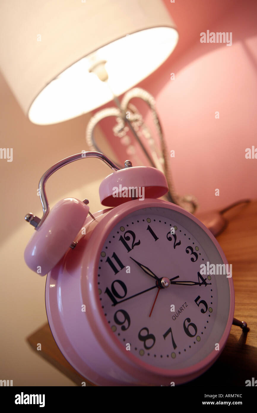 Pink bedroom in house shoing clock and lamp Stock Photo