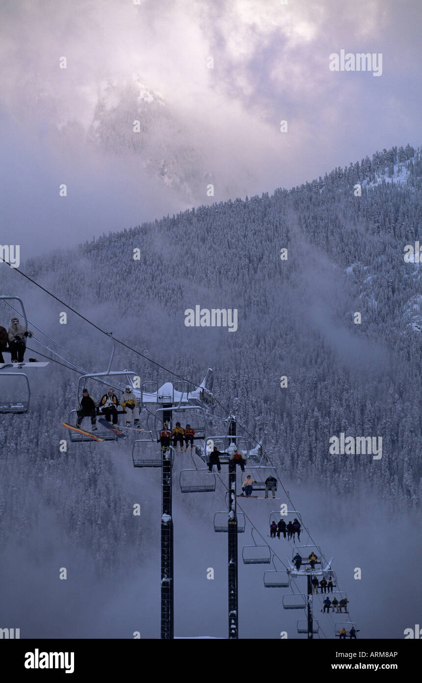 Chair lift filled with skiers and snowboarders, Mount Baker, Cascade