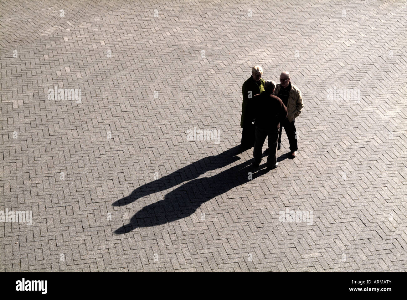 THREE FIGURES IN SILHOUETTE Stock Photo