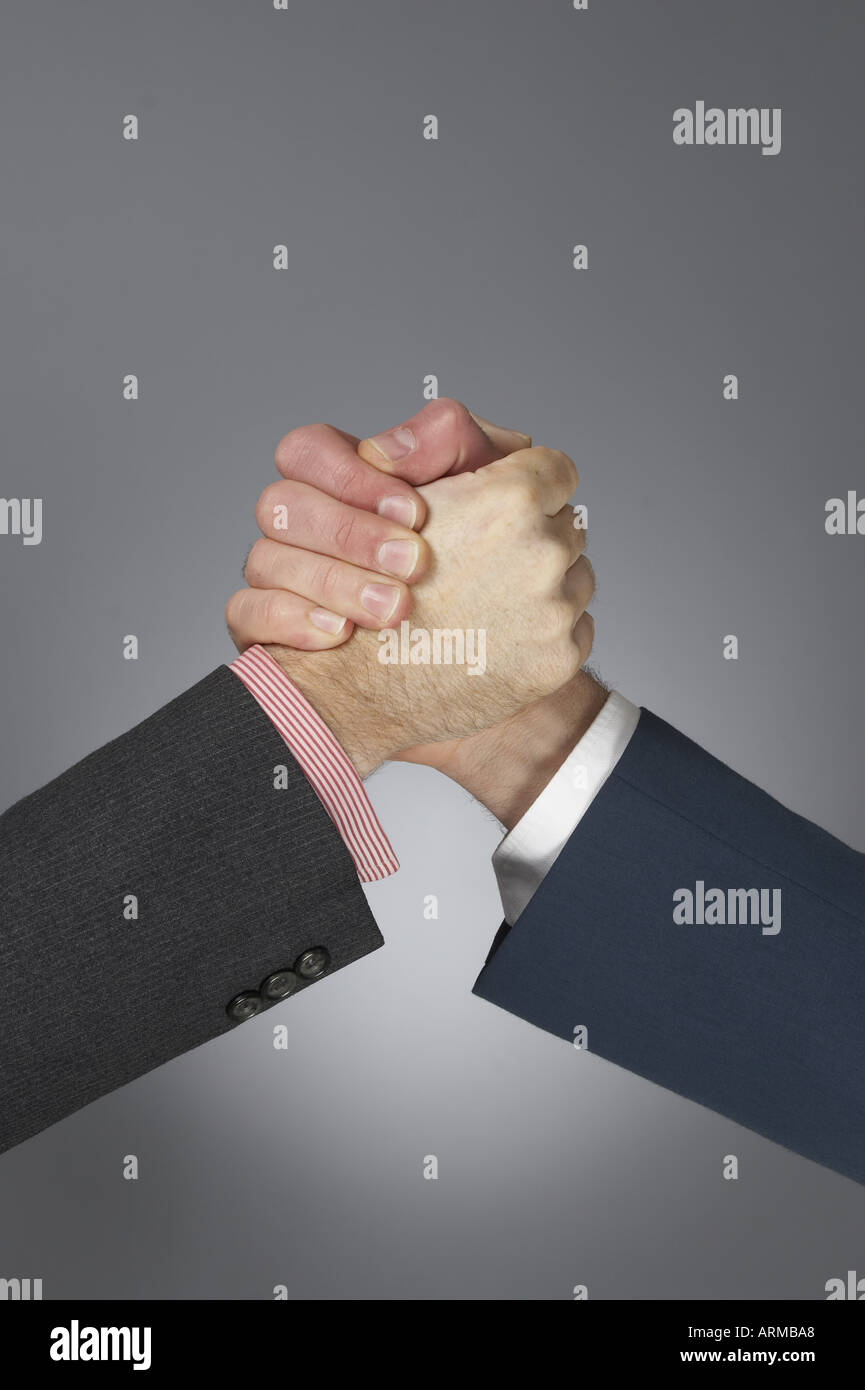 Strong upright wrist grip handshake of hand and fingers of two