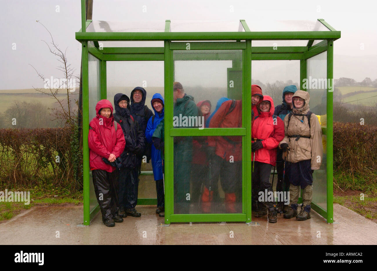 Walkers sheltering from wind and rain on New Year's Day in bus shelter on A470 road at Libanus in the Brecon Beacons Stock Photo