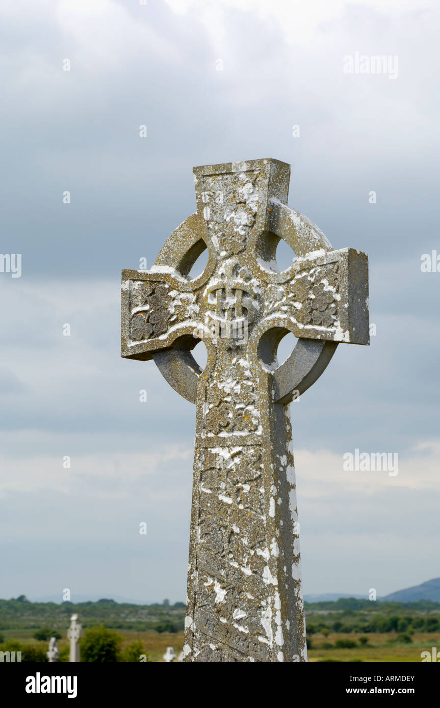 Celtic style cross in graveyard, Kilmacdaugh churches and Round Tower, County Galway, Connacht, Republic of Ireland (Eire) Stock Photo