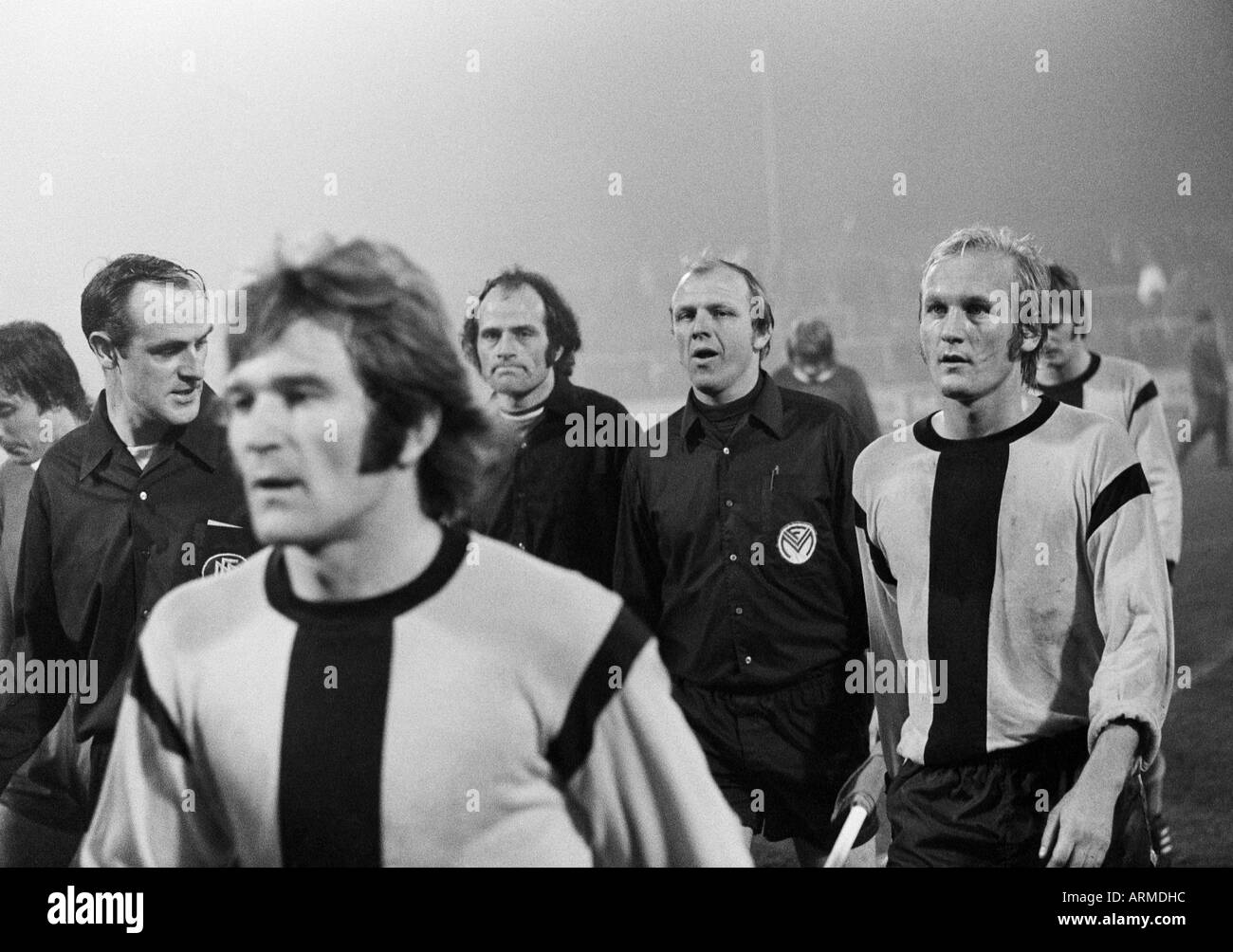 football, Regionalliga West, 1973/1974, Niederrhein Stadium in Oberhausen, Rot-Weiss Oberhausen versus Borussia Dortmund 2:1, football players leave the pitch, f.l.t.r. referee Paul Kindervater from Koeln, Willi Mumme (BVB), referee assistants, Manfred Ba Stock Photo