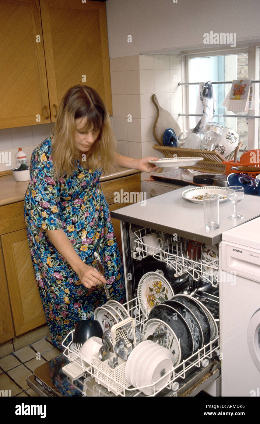 heavily pregnant woman doing housework Stock Photo