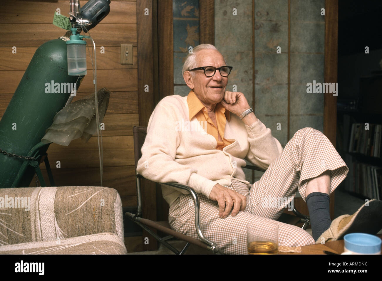 Elderly man suffering with emphysema keeps an oxygen tank at home Stock