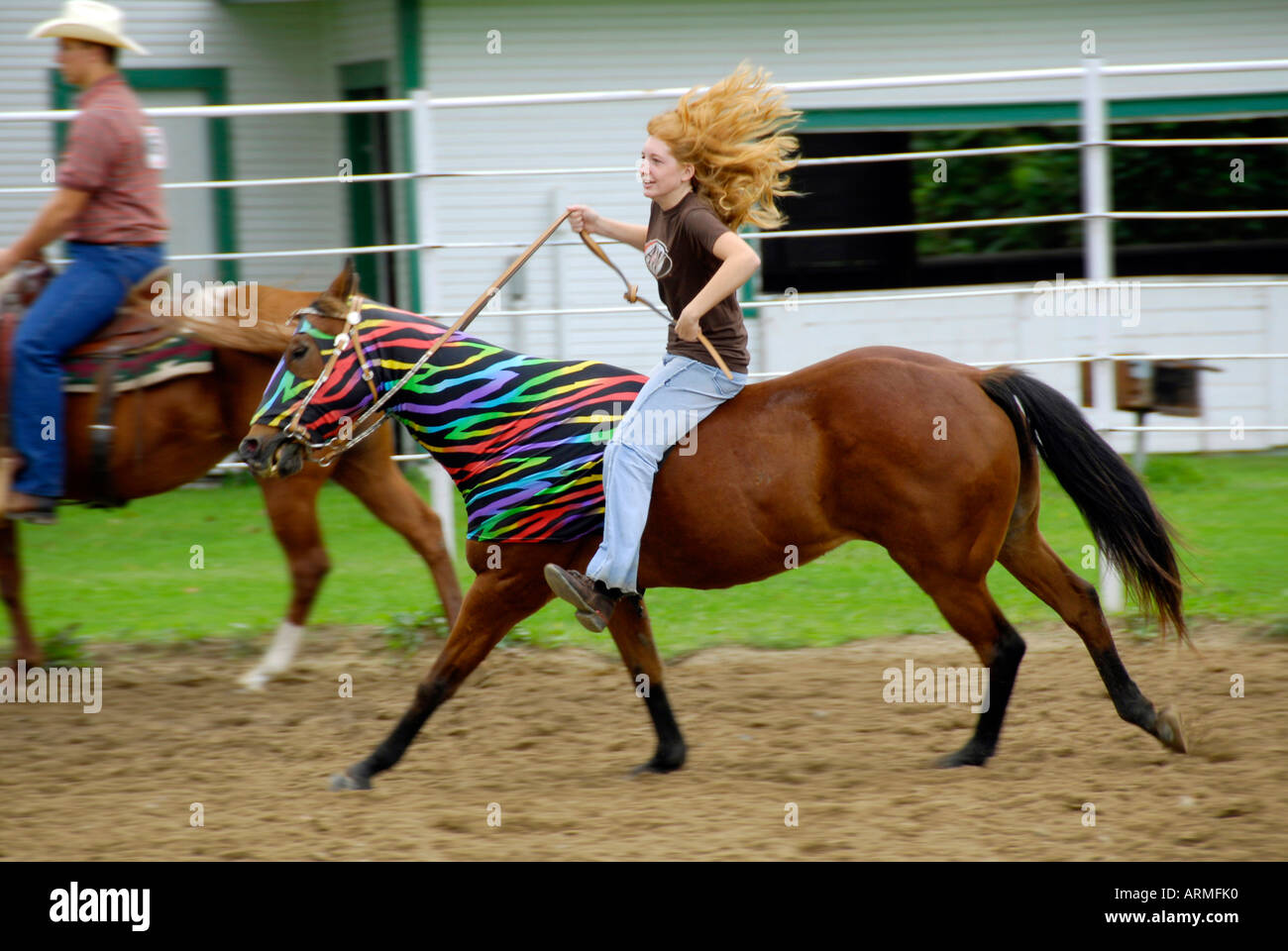 High school female student riding bareback without a saddle competes in equestrian event Stock Photo