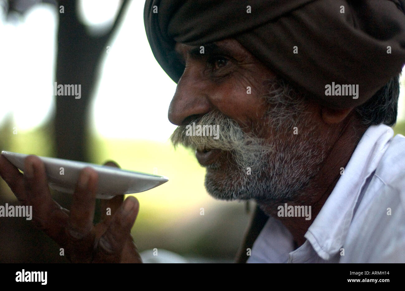 Rice farmer drinking tea from saucer Stock Photo Alamy