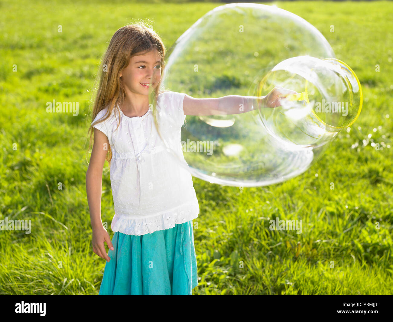 Little girl making soap bubbles Stock Photo Alamy