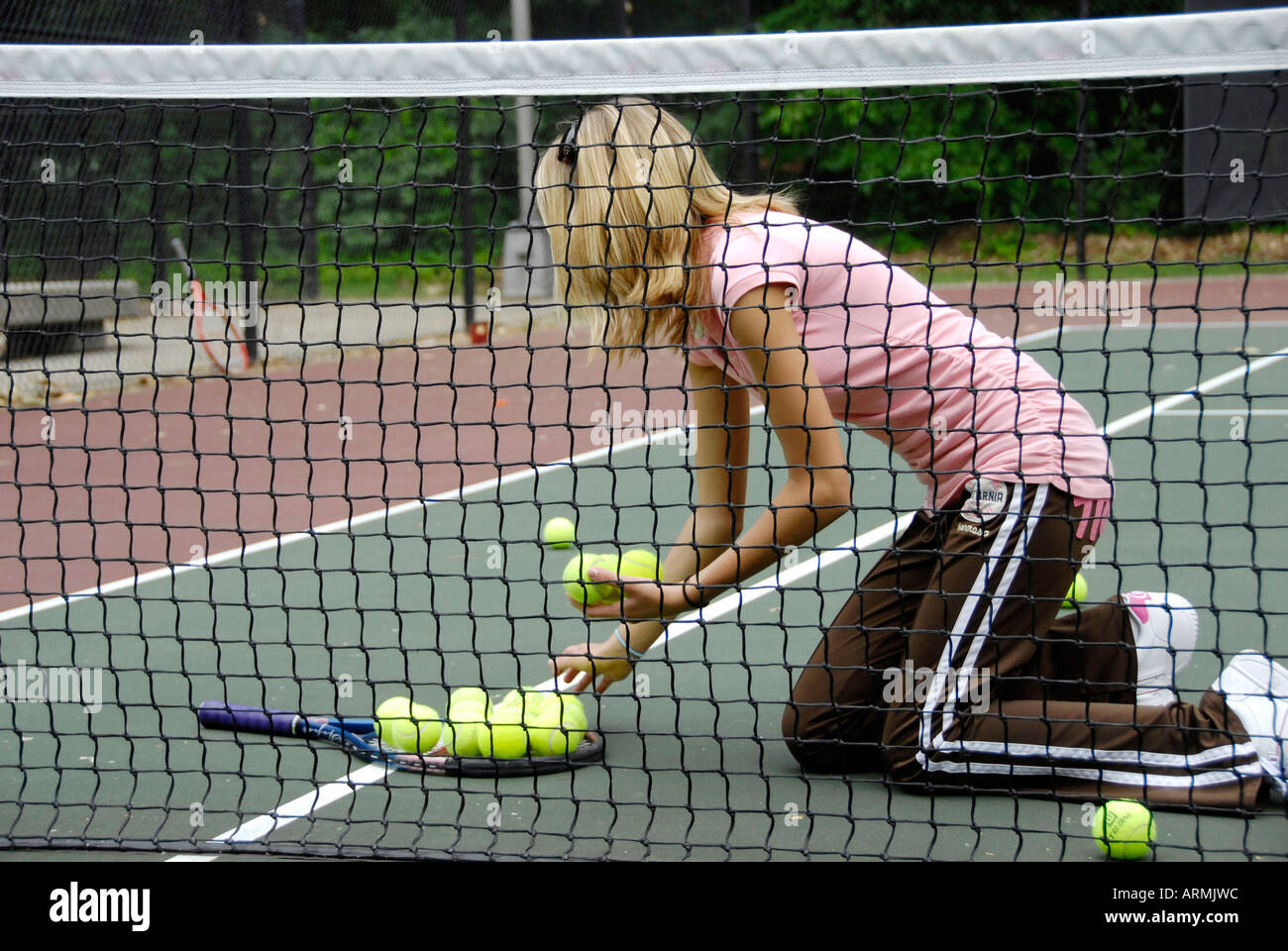 Middle school and high school age teenagers take Tennis lesson in a summer enrichment and development public city program Stock Photo