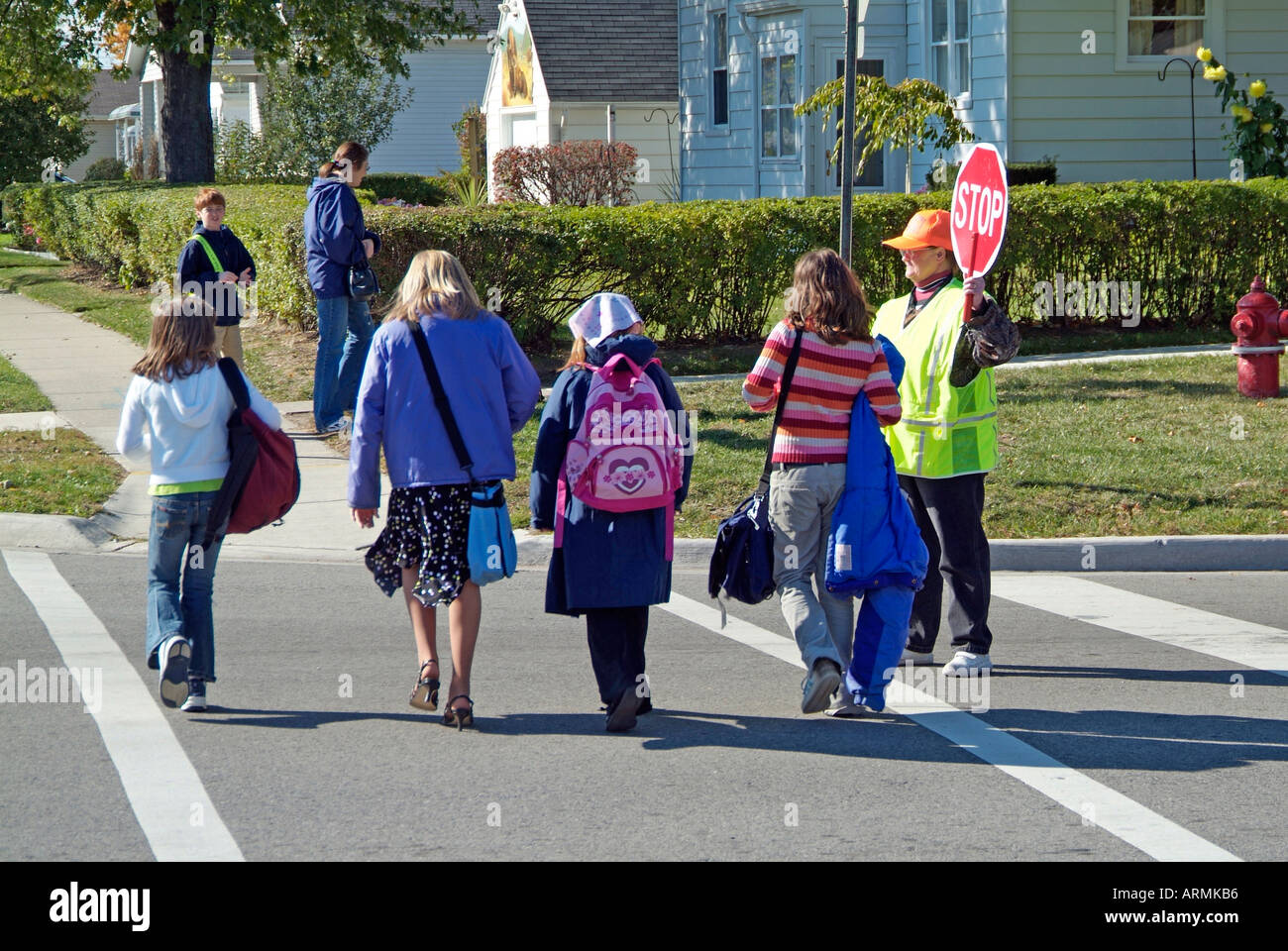 Elementary school crossing guard provides safety to children crossing