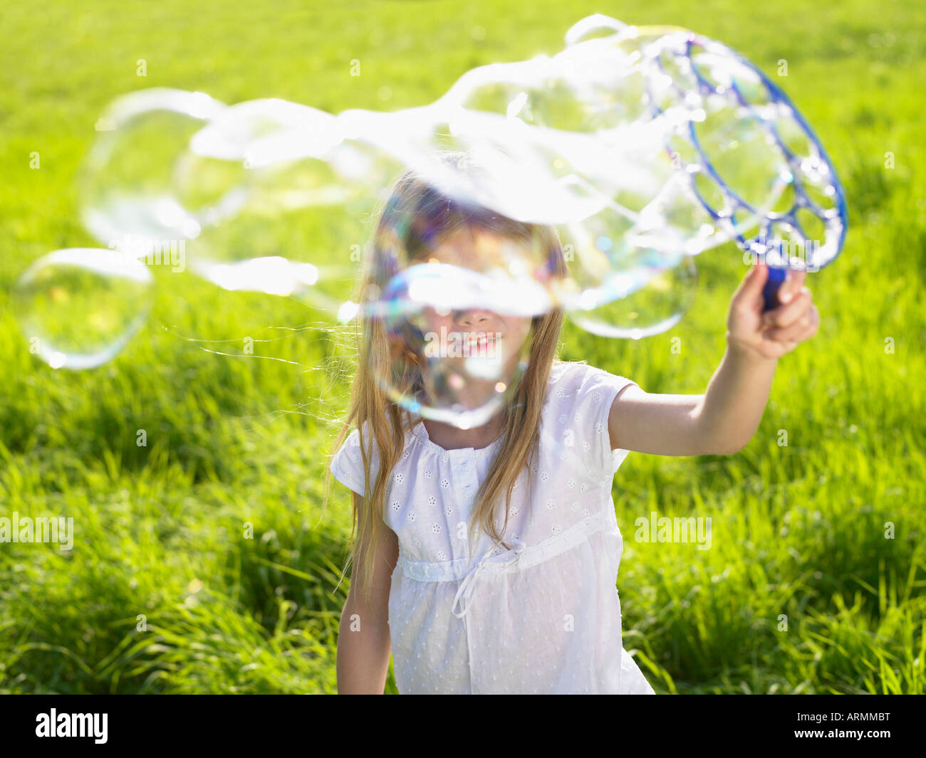 Little girl making soap bubbles Stock Photo - Alamy
