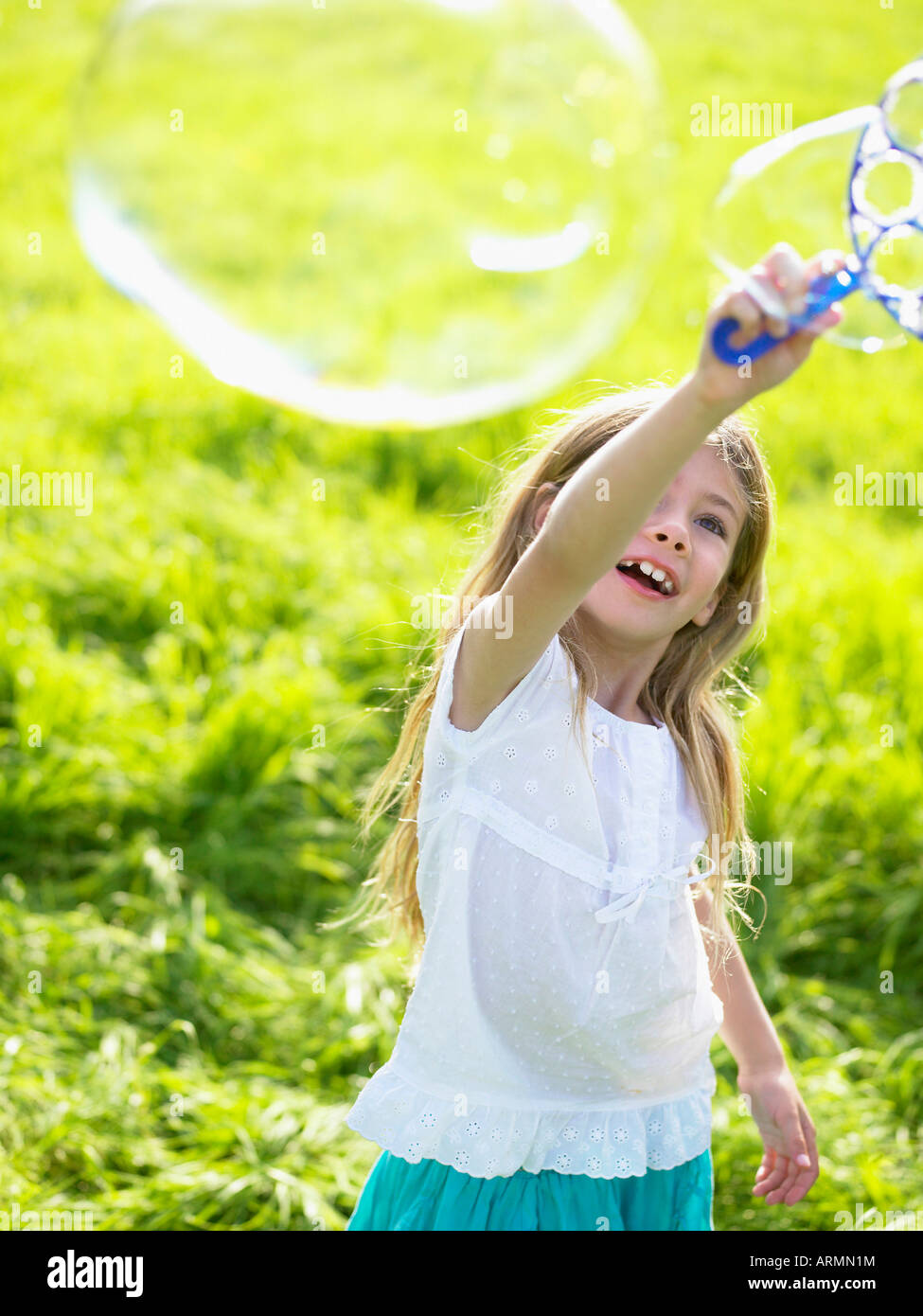 Little girl making soap bubbles Stock Photo - Alamy