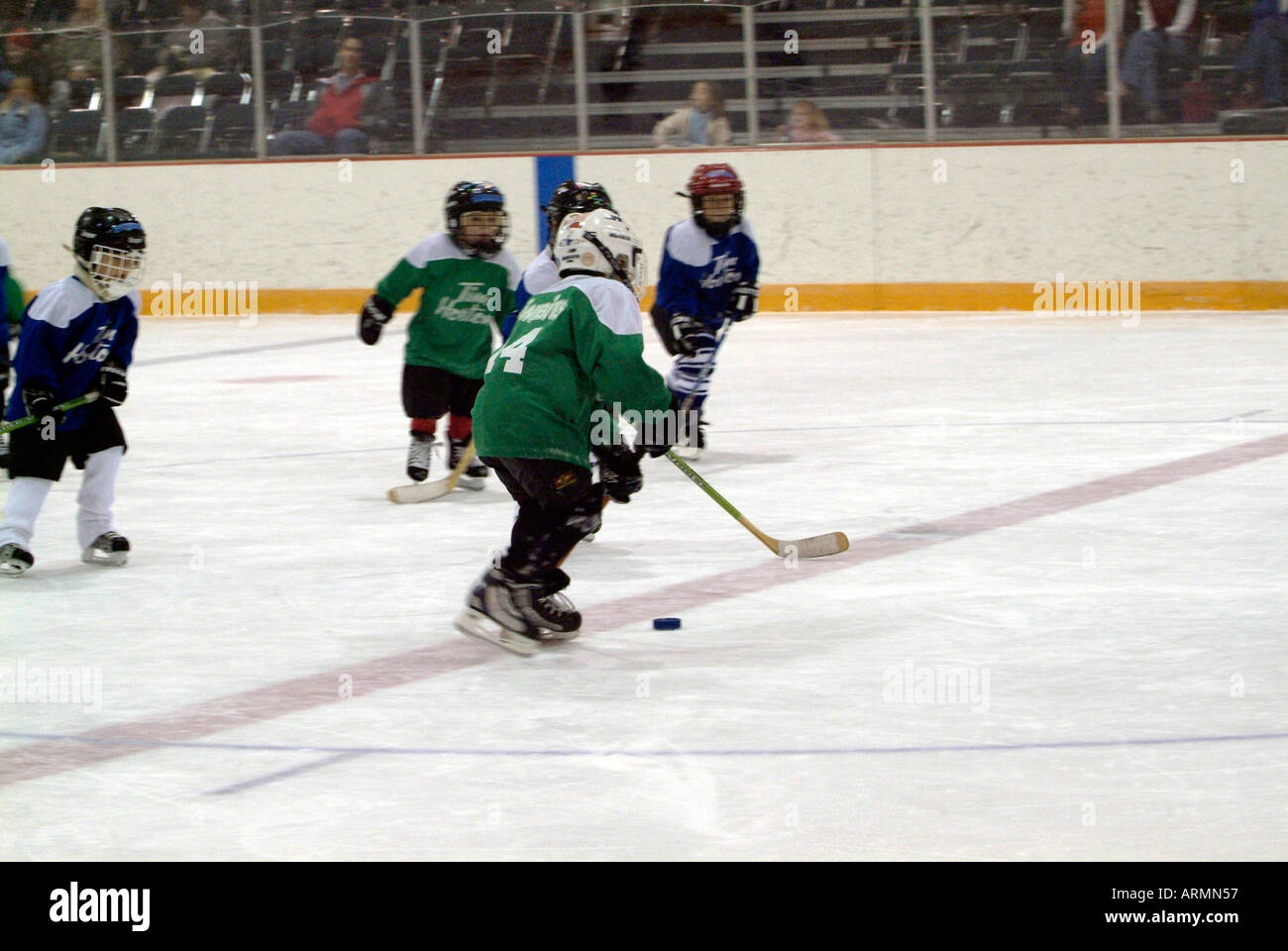 5 year old boys learn how to play the game of ice hockey Stock Photo