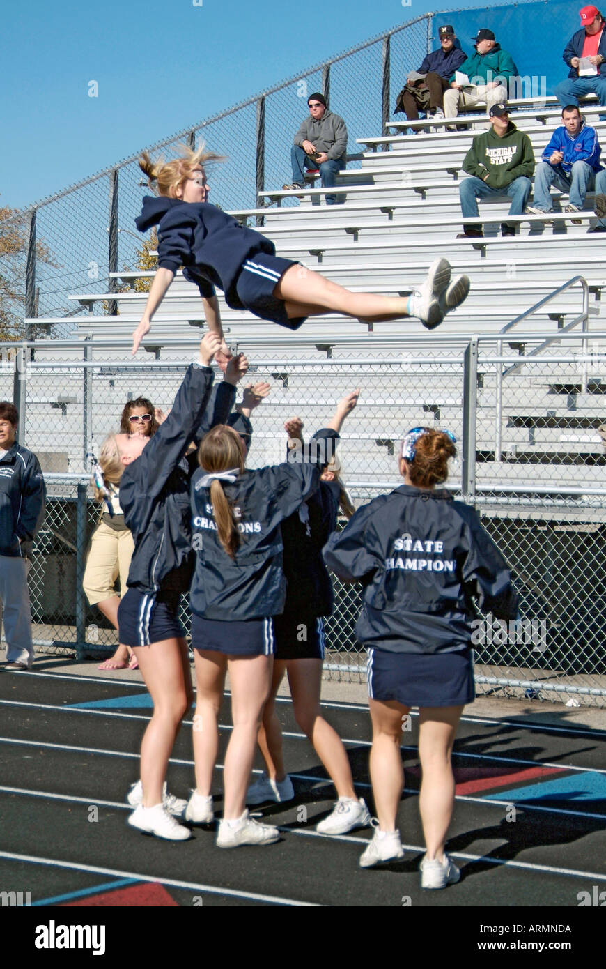 High School cheerleaders perform complicated and sometimes dangerous maneuvers during