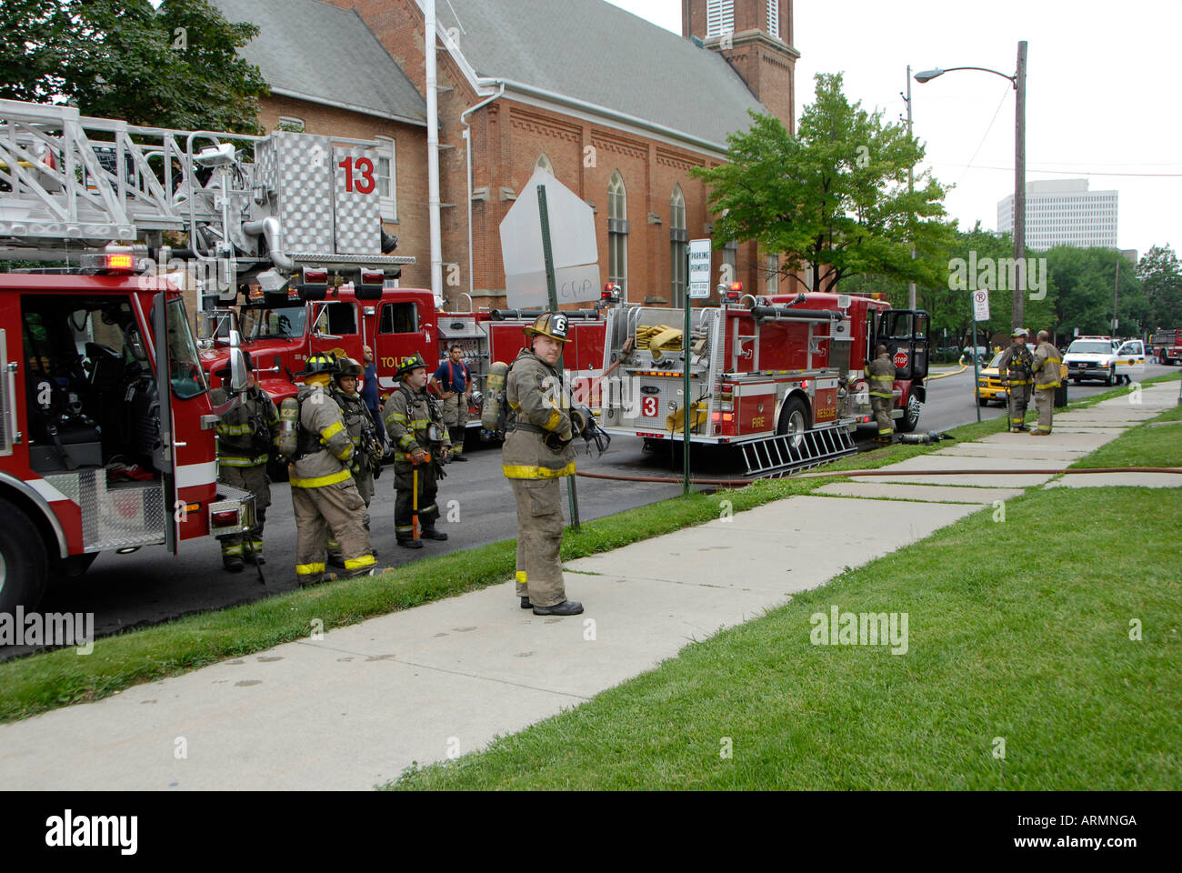 Fireman with fire fighting equipment respond to emergency fire